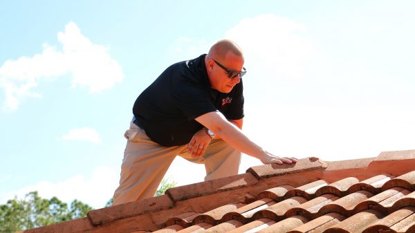 A man checking the strenght of the roof